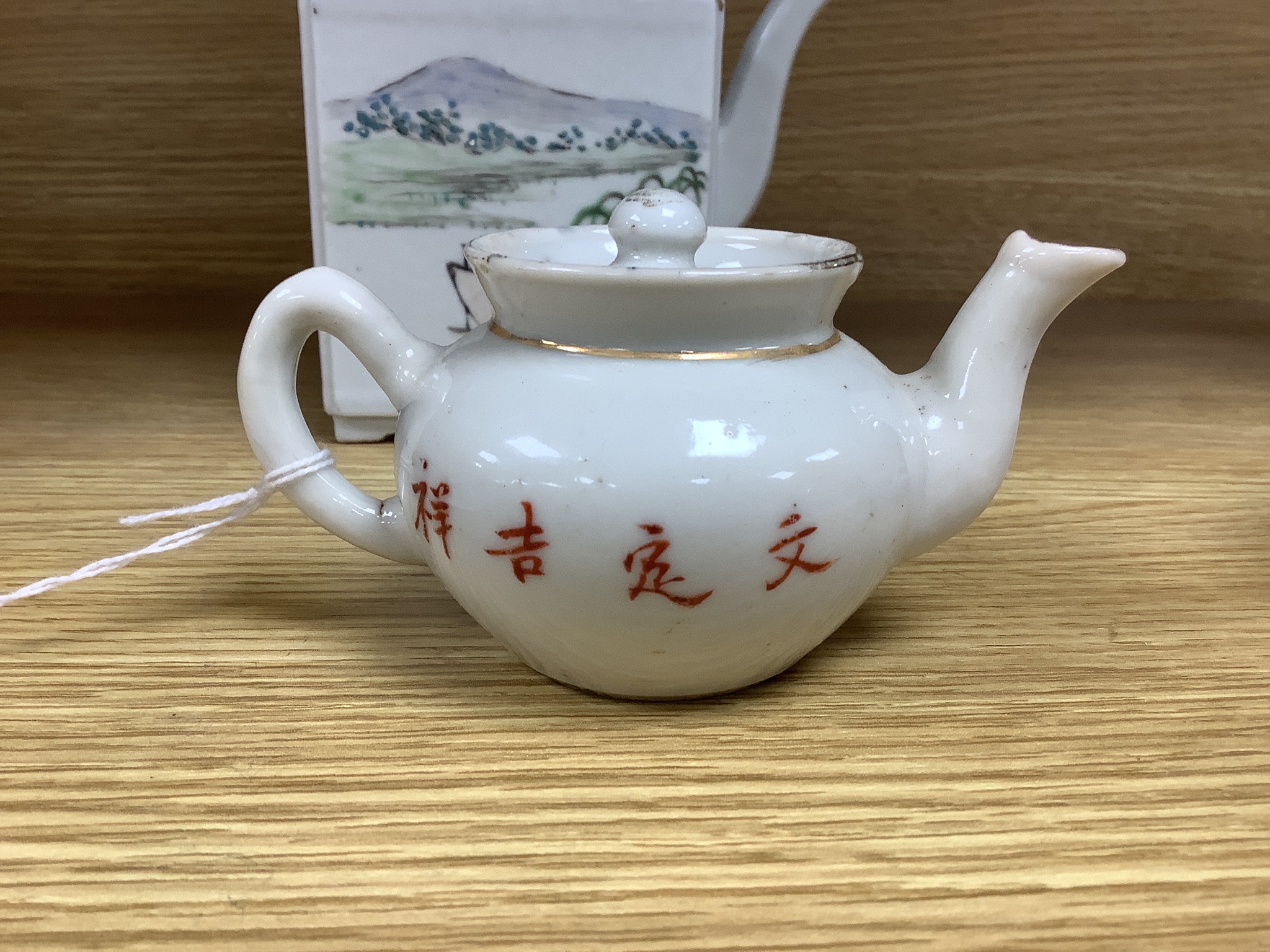 A Chinese enamelled porcelain square teapot and cover and a similar miniature teapot and cover, tallest 13cm